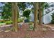 Secluded backyard retreat with a garden bench nestled among trees, mulch, and decorative stones at 1239 Bonshaw Trl, Marietta, GA 30064