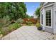 A backyard stone patio features lush landscaping, providing a serene outdoor living space at 1239 Bonshaw Trl, Marietta, GA 30064