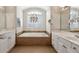 Bright bathroom with a large soaking tub and modern light fixture for a relaxing ambiance at 1239 Bonshaw Trl, Marietta, GA 30064