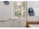 Bright bathroom with single vanity, framed mirror, and decorative wall art at 1239 Bonshaw Trl, Marietta, GA 30064