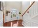 Bright foyer featuring hardwood floors, a staircase, and white wainscoting at 1239 Bonshaw Trl, Marietta, GA 30064