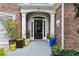 Elegant front door with decorative glass, flanked by columns and potted plants, creating a welcoming entrance at 1239 Bonshaw Trl, Marietta, GA 30064