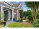 Inviting front entrance with brick facade, arched doorway, and manicured plants leading to front door at 1239 Bonshaw Trl, Marietta, GA 30064
