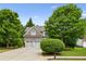 Traditional two-story brick home with a well-manicured front lawn, mature trees, and a two-car garage at 1239 Bonshaw Trl, Marietta, GA 30064