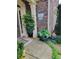 Inviting front porch with brick siding, potted plants, and decorative sign at 1239 Bonshaw Trl, Marietta, GA 30064