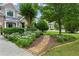 Charming front yard with lush flowerbeds, stone pathway, and mature landscaping creating curb appeal at 1239 Bonshaw Trl, Marietta, GA 30064