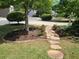 Charming front yard featuring a stone walkway and meticulously manicured landscaping at 1239 Bonshaw Trl, Marietta, GA 30064