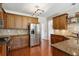 Modern kitchen features granite countertops, stainless steel appliances, and wood cabinets at 1239 Bonshaw Trl, Marietta, GA 30064
