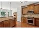 Well-lit kitchen with stainless steel appliances, granite countertops, and light brown wood cabinetry at 1239 Bonshaw Trl, Marietta, GA 30064