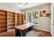 Well-lit home office with built in shelves, large work table and colorful rug at 1239 Bonshaw Trl, Marietta, GA 30064