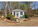 Charming shed with double doors, white trim, and surrounding landscaping at 1239 Bonshaw Trl, Marietta, GA 30064