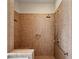 Tiled shower with upgraded showerhead, bench and convenient grab bars offers accessibility and comfort at 1239 Bonshaw Trl, Marietta, GA 30064