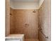 Walk-in shower featuring neutral tile surround, rainfall showerhead and bench seat at 1239 Bonshaw Trl, Marietta, GA 30064