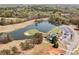 Scenic aerial view of the golf course and lake with the clubhouse and parking lot at 179 Country Club Dr, Hiram, GA 30141