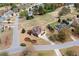 Aerial view showcasing the home nestled in a serene community with lush green spaces and tree coverage at 179 Country Club Dr, Hiram, GA 30141