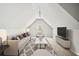 Finished attic space with neutral decor, plush seating, and modern media setup at 179 Country Club Dr, Hiram, GA 30141