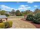 Beautiful backyard showcasing a lush lawn, mature trees, elegant landscaping, and privacy fence at 179 Country Club Dr, Hiram, GA 30141