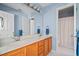 Clean bathroom with double sinks, wood cabinets, and a separate shower, providing convenience and functionality at 179 Country Club Dr, Hiram, GA 30141