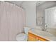 Clean bathroom with a toilet, sink, and tiled shower, perfect for daily routines at 179 Country Club Dr, Hiram, GA 30141