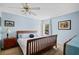 Comfortable bedroom with a ceiling fan, wood furniture, and light blue walls, creating a relaxing atmosphere at 179 Country Club Dr, Hiram, GA 30141