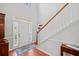 Bright foyer with hardwood floors, staircase, and a view of the front door at 179 Country Club Dr, Hiram, GA 30141