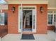 Inviting front entry with double glass doors, brick exterior, and stylish sconces at 179 Country Club Dr, Hiram, GA 30141