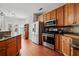 Bright kitchen features wood cabinets, stainless appliances, and a granite countertop bar at 179 Country Club Dr, Hiram, GA 30141