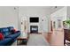 Inviting living room with a cozy fireplace, TV, and comfortable blue sofa at 179 Country Club Dr, Hiram, GA 30141