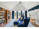 Bright living room boasts vaulted ceilings, oversized windows, and custom bookshelves at 179 Country Club Dr, Hiram, GA 30141