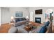 Bright living room with a fireplace, hardwood floors, and contemporary furnishings at 179 Country Club Dr, Hiram, GA 30141