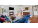 Spacious living room featuring a cozy fireplace, TV, and hardwood floors at 179 Country Club Dr, Hiram, GA 30141