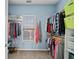 A walk-in closet features ample hanging space and shelving for storage, maximizing organization at 179 Country Club Dr, Hiram, GA 30141