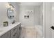 Bathroom with double vanity, marble floor, and modern fixtures at 2018 Presley Ne Way, Atlanta, GA 30317