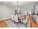 Elegant dining area with modern light fixture and view to the kitchen at 2018 Presley Ne Way, Atlanta, GA 30317