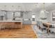 Open kitchen and dining area with gray cabinets and modern light fixtures at 2018 Presley Ne Way, Atlanta, GA 30317