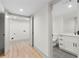 Modern bathroom with white cabinets, marble countertop, gray tile floor, and stainless steel accents at 3216 Woodview Se Dr, Smyrna, GA 30082