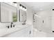 Modern bathroom featuring double sinks, sleek fixtures, and a glass-enclosed shower at 3216 Woodview Se Dr, Smyrna, GA 30082