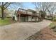 Rear exterior view of the home showcasing a large deck and driveway at 3216 Woodview Se Dr, Smyrna, GA 30082