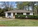 Charming home featuring a lush green lawn, inviting curb appeal and a freshly painted exterior at 3216 Woodview Se Dr, Smyrna, GA 30082
