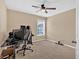 Bedroom featuring neutral carpeting, a ceiling fan, and filled with modern computer equipment at 709 Mountain Laurel Dr, Canton, GA 30114