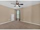 Spacious bedroom with neutral carpeting, ceiling fan, and a window for natural light at 709 Mountain Laurel Dr, Canton, GA 30114