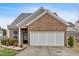 Charming single-story brick home with a two-car garage and well-maintained landscaping at 709 Mountain Laurel Dr, Canton, GA 30114