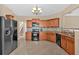 Spacious kitchen with wooden cabinets, tile backsplash, black appliances and an open layout at 709 Mountain Laurel Dr, Canton, GA 30114