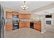 Well-equipped kitchen featuring wooden cabinets, tile backsplash, and modern appliances at 709 Mountain Laurel Dr, Canton, GA 30114