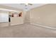 Open-concept living area with neutral walls, carpeted floors, and a view of the kitchen at 709 Mountain Laurel Dr, Canton, GA 30114