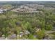 Aerial view showing a neighborhood with lush trees and backyard pools at 1068 Gwens Sw Trl, Lilburn, GA 30047