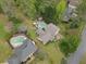 Aerial view featuring backyards with swimming pools and mature trees at 1068 Gwens Sw Trl, Lilburn, GA 30047
