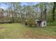 Large backyard with mature trees and small outbuildings offers outdoor recreation and relaxation at 1068 Gwens Sw Trl, Lilburn, GA 30047