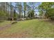 Expansive backyard with lush lawn, and storage sheds, perfect for outdoor gatherings at 1068 Gwens Sw Trl, Lilburn, GA 30047
