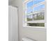 Bright bathroom featuring a window, shower curtain and white fixtures at 1068 Gwens Sw Trl, Lilburn, GA 30047